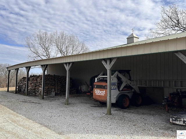 view of car parking with an outbuilding and a carport