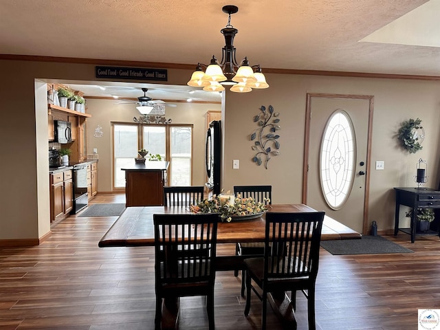 dining area with a textured ceiling, ornamental molding, wood finished floors, and a healthy amount of sunlight