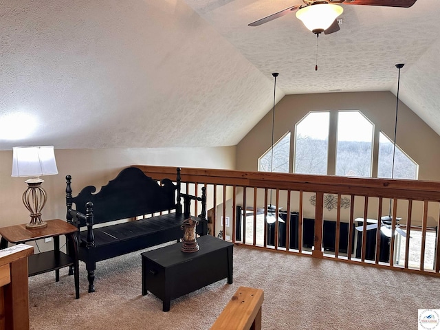 sitting room featuring a ceiling fan, carpet, vaulted ceiling, and a textured ceiling