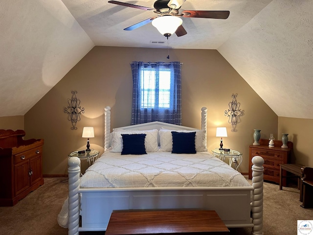 carpeted bedroom with baseboards, visible vents, a ceiling fan, lofted ceiling, and a textured ceiling