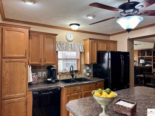 kitchen featuring brown cabinetry, dark countertops, a sink, and black appliances