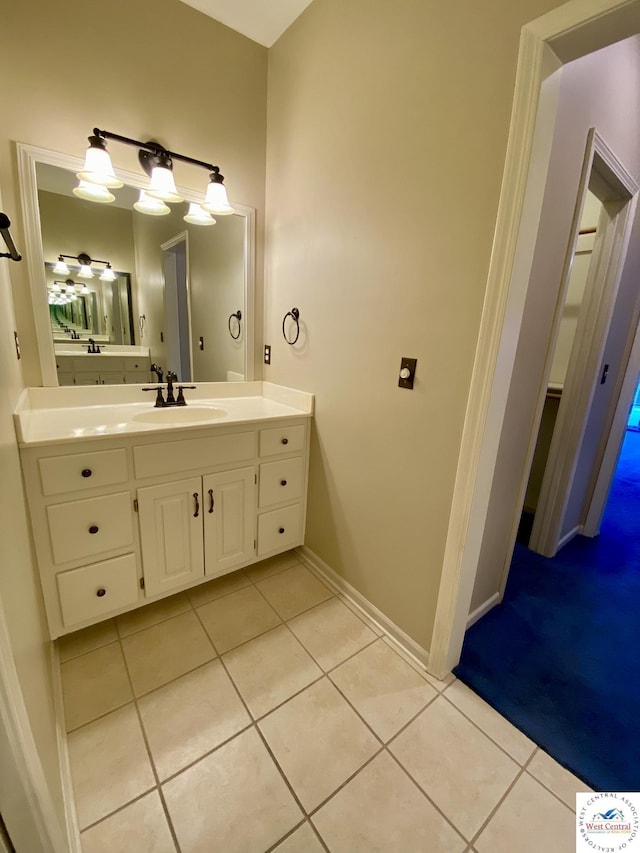 bathroom featuring tile patterned flooring, vanity, and baseboards