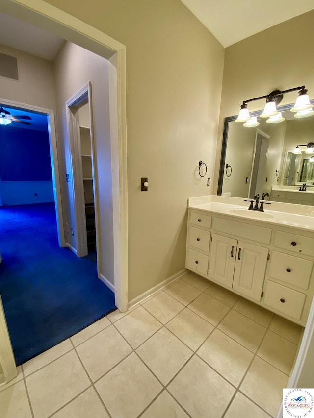 bathroom featuring tile patterned flooring, baseboards, and vanity