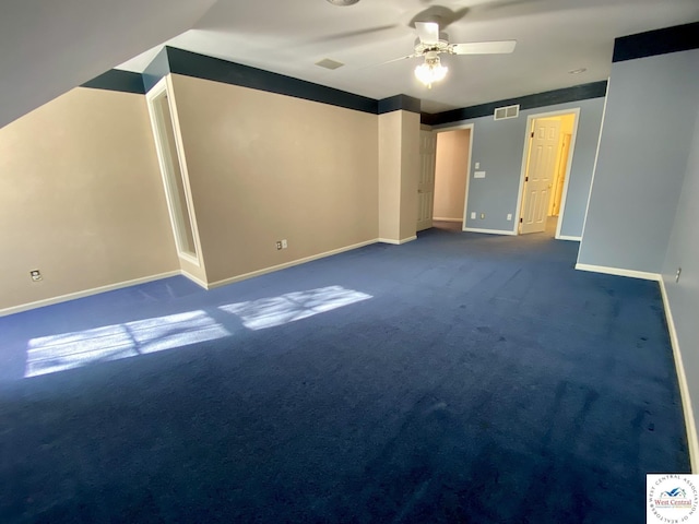 unfurnished bedroom featuring a ceiling fan, dark carpet, visible vents, and baseboards