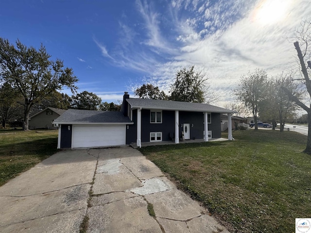 view of front of home with a chimney, covered porch, an attached garage, driveway, and a front lawn