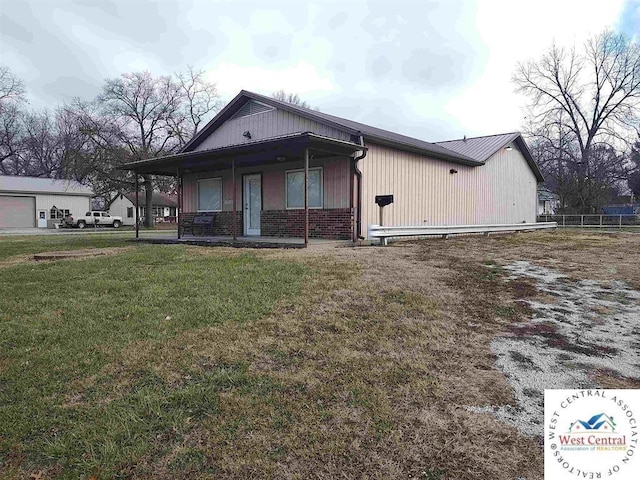 view of front of property with a porch, a front yard, and brick siding