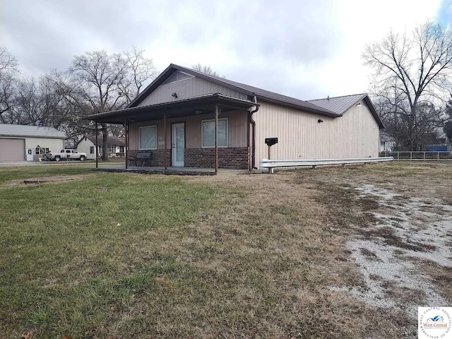 view of front of house with covered porch, brick siding, and a front lawn