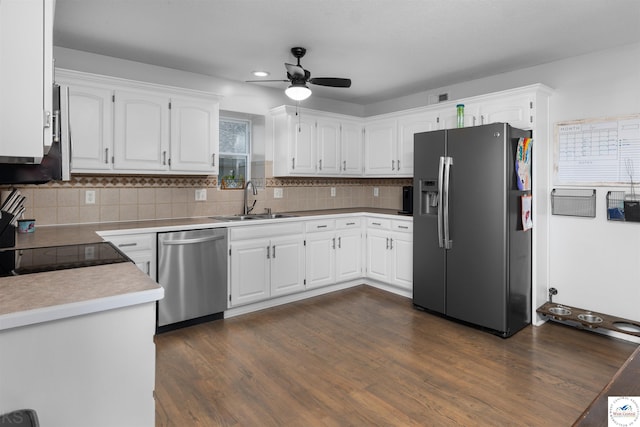 kitchen with a sink, ceiling fan, appliances with stainless steel finishes, white cabinets, and dark wood-style flooring