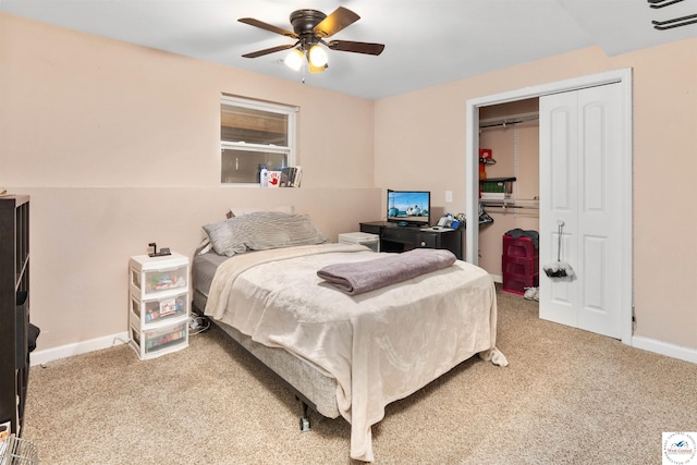 carpeted bedroom with a closet, a ceiling fan, and baseboards