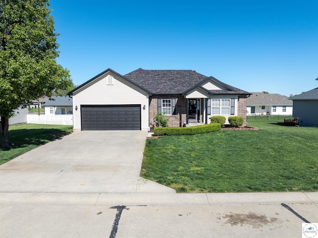 ranch-style house featuring a front yard, fence, driveway, a garage, and brick siding