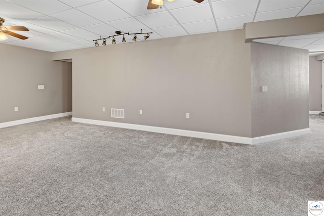 interior space featuring visible vents, baseboards, a paneled ceiling, and ceiling fan