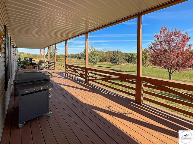 wooden deck with a yard and area for grilling