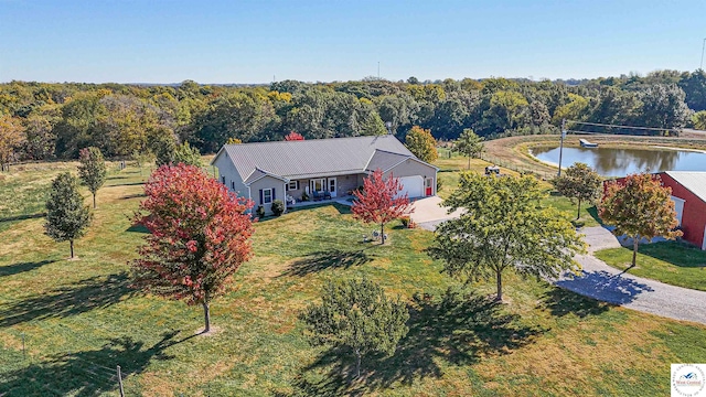 aerial view featuring a water view and a view of trees