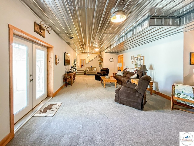 carpeted living room featuring wood ceiling, baseboards, stairway, and french doors