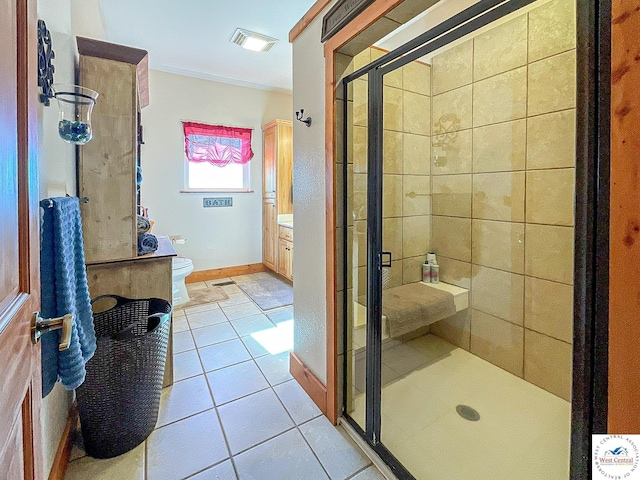 bathroom with toilet, visible vents, vanity, tile patterned floors, and a stall shower