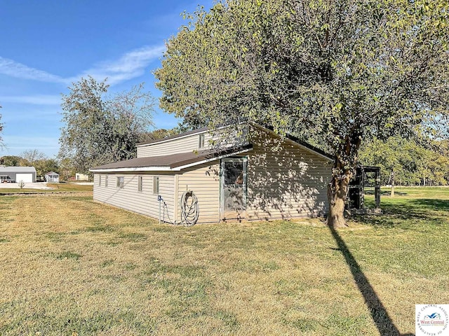 view of property exterior with a yard