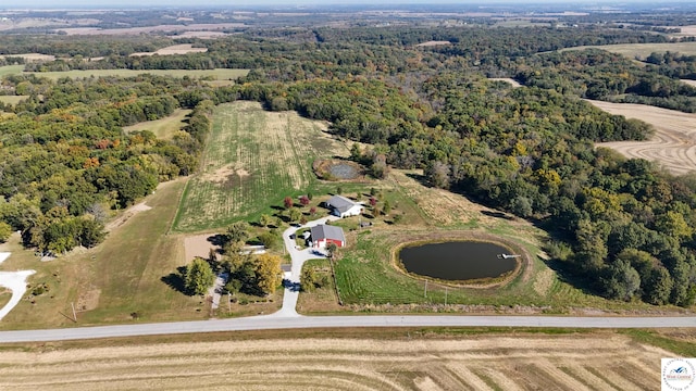 bird's eye view with a water view and a wooded view