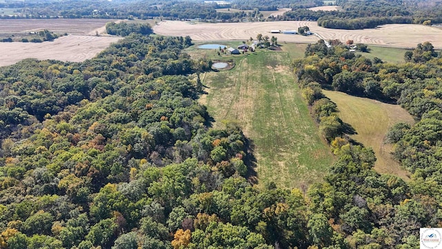 birds eye view of property featuring a forest view and a rural view