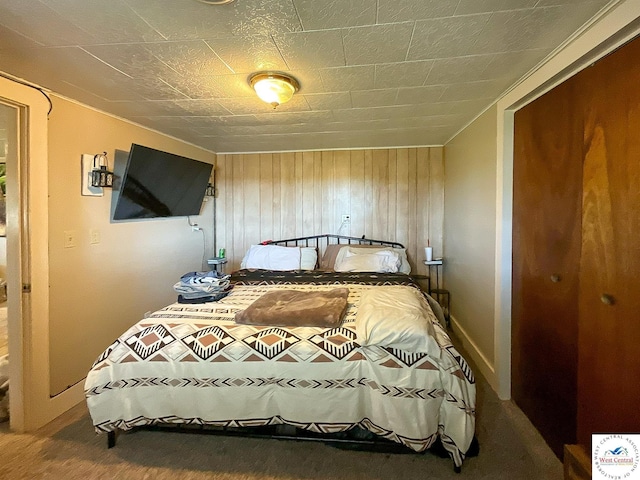 bedroom with wooden walls and baseboards