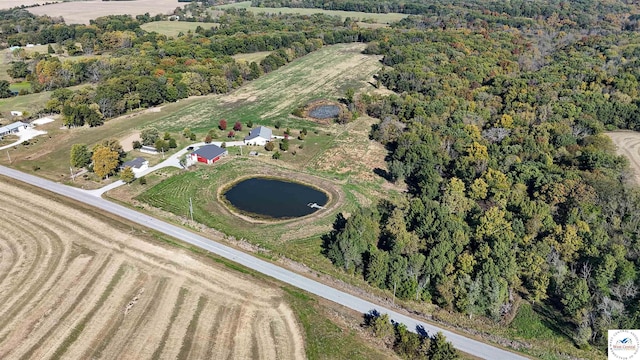 aerial view featuring a water view and a forest view