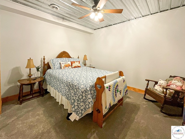 bedroom featuring baseboards, dark carpet, and ceiling fan