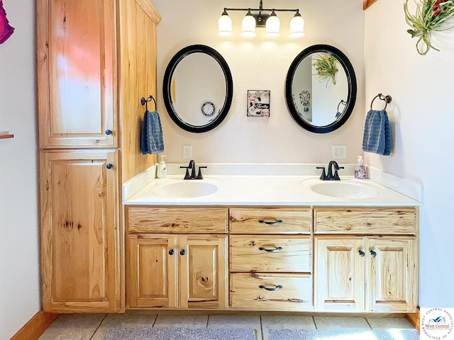 bathroom featuring double vanity, tile patterned flooring, and a sink