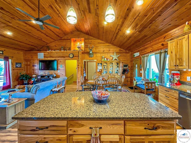 kitchen featuring wood ceiling, open floor plan, vaulted ceiling, wooden walls, and dishwasher