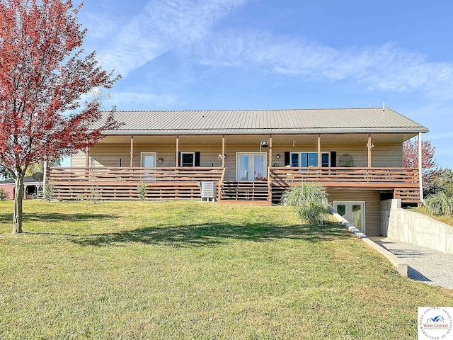 view of front of home with metal roof, french doors, and a front yard