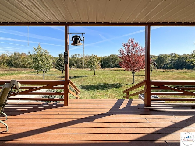 wooden deck featuring a lawn