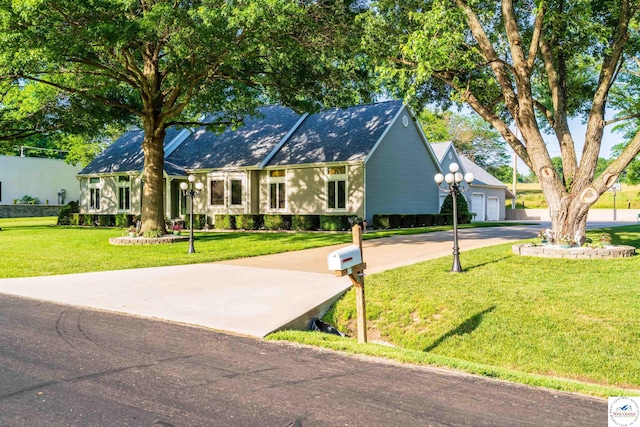 ranch-style house with a front yard and concrete driveway