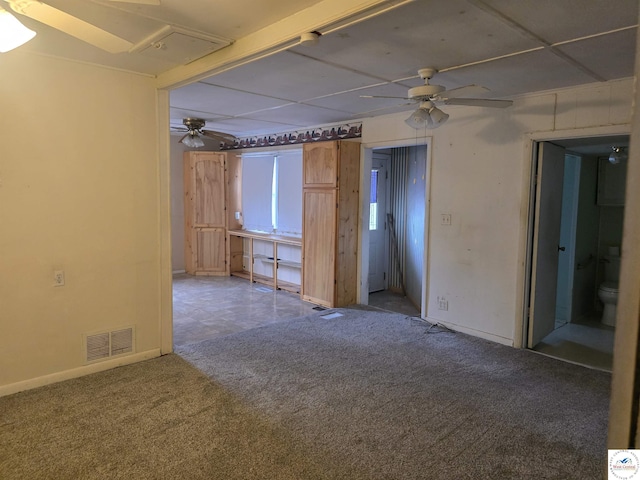 unfurnished room featuring carpet, visible vents, ceiling fan, and baseboards