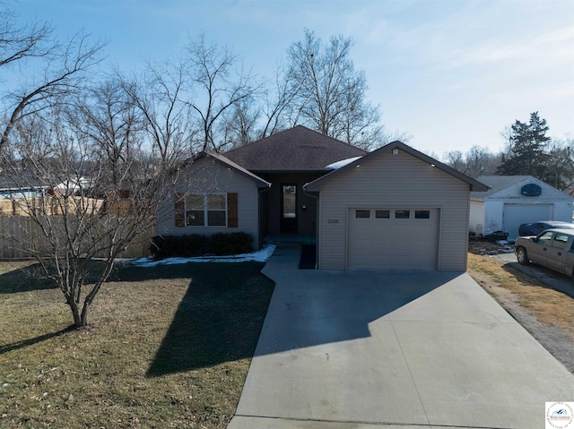 single story home featuring a garage, concrete driveway, and a front yard