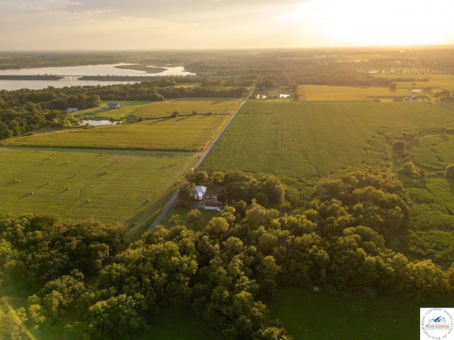 aerial view at dusk with a water view and a rural view