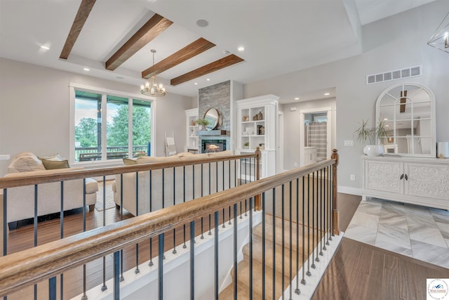 corridor featuring visible vents, beamed ceiling, an upstairs landing, a chandelier, and recessed lighting