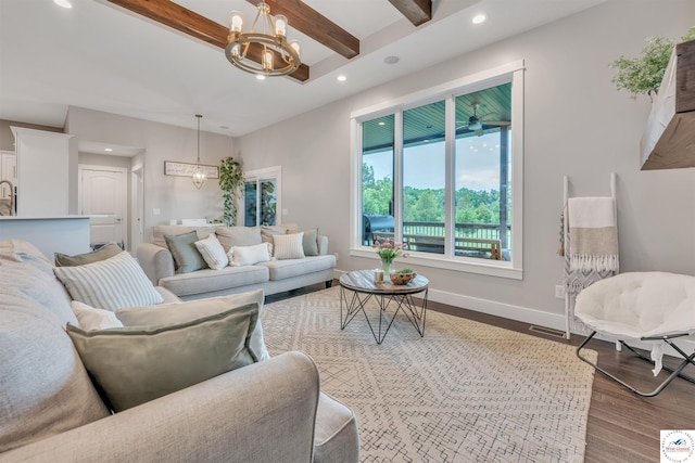 living area with baseboards, beamed ceiling, wood finished floors, a chandelier, and recessed lighting