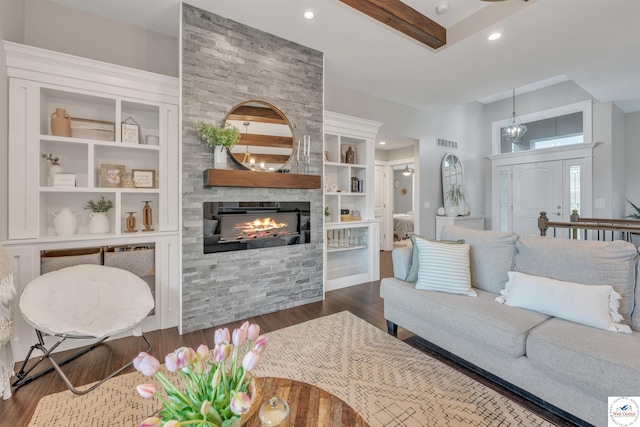 living area with visible vents, built in features, dark wood-style floors, a fireplace, and recessed lighting