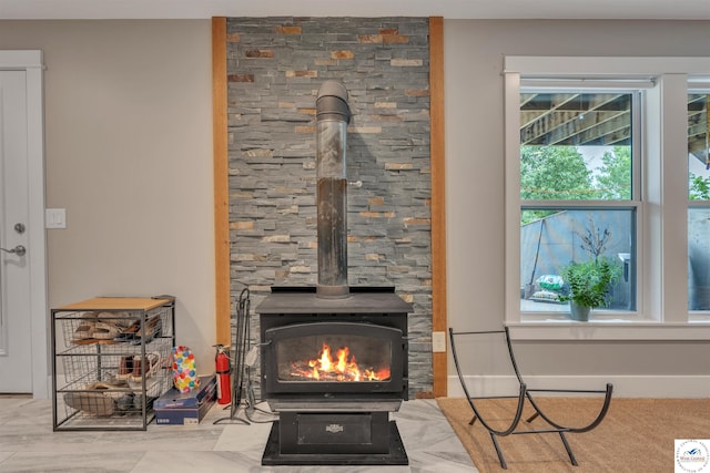 details featuring a wood stove and baseboards