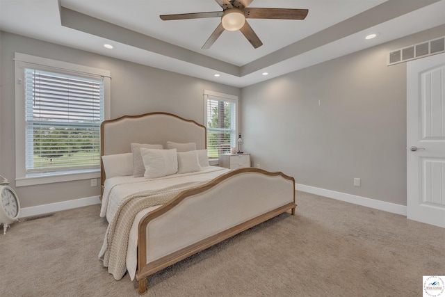 bedroom featuring light colored carpet, visible vents, and baseboards