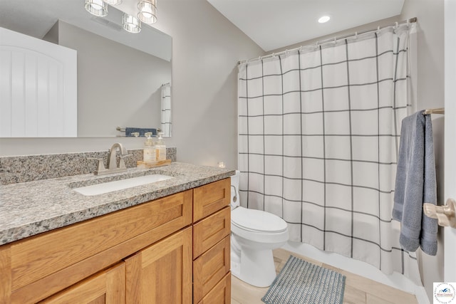 full bath with toilet, tile patterned floors, shower / bath combo, and vanity