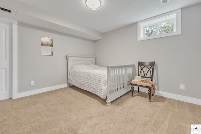 bedroom with light carpet and baseboards