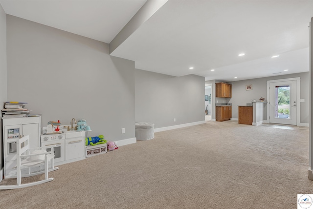 game room featuring baseboards, recessed lighting, and light colored carpet