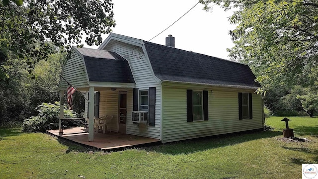 view of property exterior with a lawn, a gambrel roof, a chimney, roof with shingles, and cooling unit