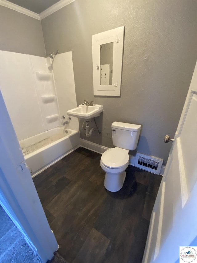 bathroom featuring toilet, wood finished floors, visible vents, shower / bathing tub combination, and crown molding