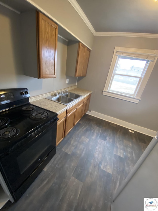 kitchen with brown cabinets, crown molding, light countertops, electric range, and a sink