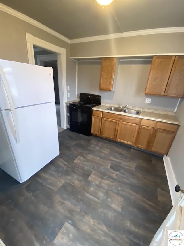 kitchen featuring black range with electric cooktop, a sink, light countertops, freestanding refrigerator, and crown molding