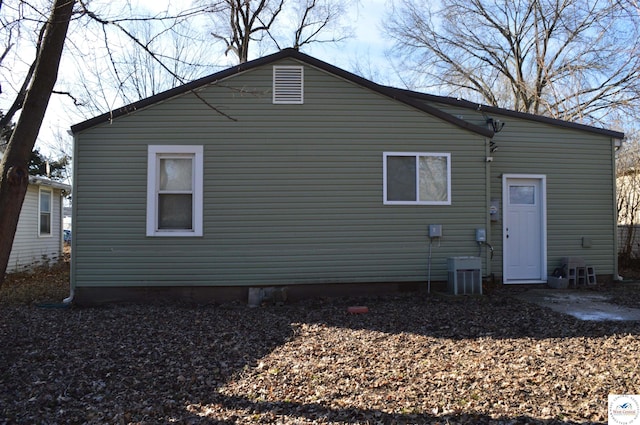 back of house with central air condition unit