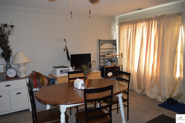 dining space with ceiling fan and carpet floors