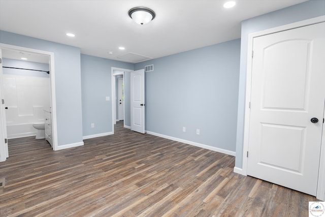 unfurnished bedroom featuring dark wood-style floors, recessed lighting, visible vents, attic access, and baseboards