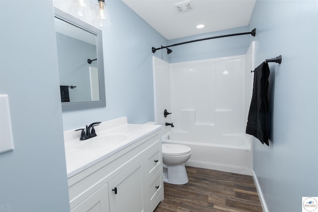 full bath with toilet, wood finished floors, vanity, bathing tub / shower combination, and visible vents