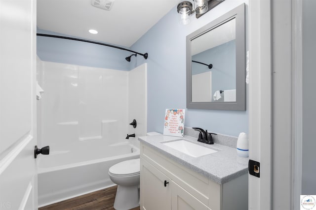 bathroom featuring toilet, wood finished floors, vanity, visible vents, and tub / shower combination